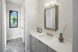 Bathroom with vanity and baseboards