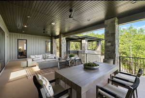 View of patio with an outdoor living space and ceiling fan