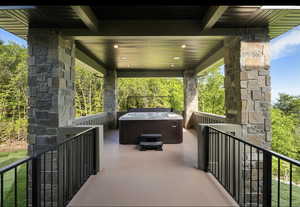 View of patio with a hot tub