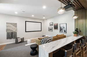 Home theater with recessed lighting and baseboards