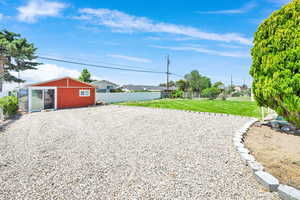 Ample parking, manicured yard, and large shed with power