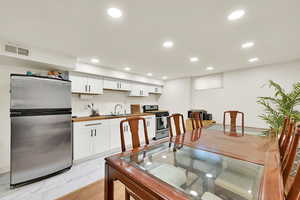 Brand New basement kitchen with butcher block counters, new cabinets, new appliances, new floors and can lighting