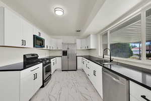 Upstairs Kitchen with new; Flooring, cabinets, appliances, light fixture, quartz counters