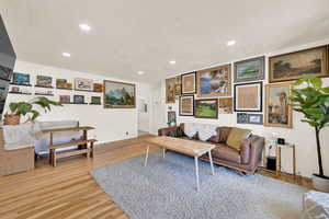 Front entry room with wood flooring, can lights, loads of natural light
