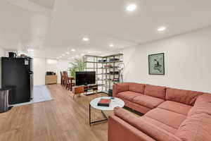Basement living room that opens to the dining and new basement kitchen