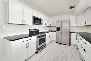 Upstairs Kitchen with new; Flooring, cabinets, appliances, light fixture, quartz counters
