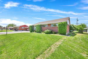 Front angle of the brick rambler from the other corner of the property