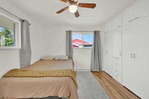 Bedroom 1 upstairs with hardwood floors and large built-in closet