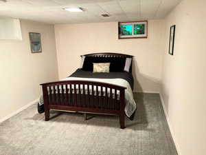Carpeted bedroom featuring baseboards