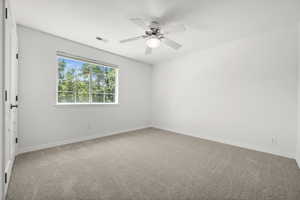 Carpeted spare bedroom .