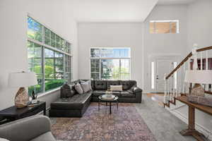 Living area with a high ceiling and stairs