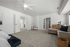 Living room featuring ornamental molding, a ceiling fan, carpet flooring.