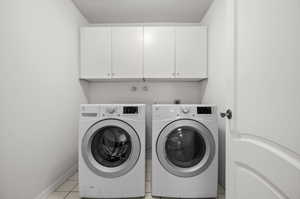 Laundry area with cabinet space, washing machine and dryer.