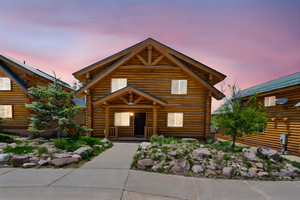 Cabin with log exterior and a porch