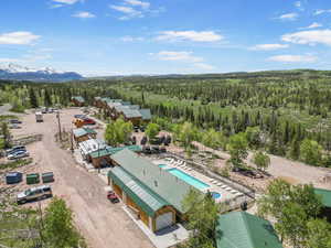 Drone / aerial view of a forest and a pool/hot tubs