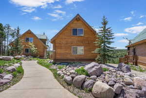 View of home's exterior featuring log siding and metal roof