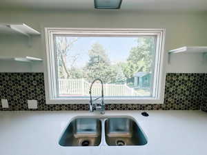 Kitchen with a sink, tasteful backsplash, and plenty of natural light