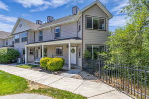 Multi unit property with central AC unit, a chimney, a shingled roof, and a porch
