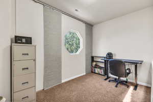 Office space featuring carpet and baseboards