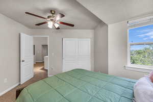 Bedroom with carpet, baseboards, a closet, and a ceiling fan