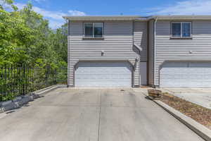 View of front facade featuring a garage and concrete driveway