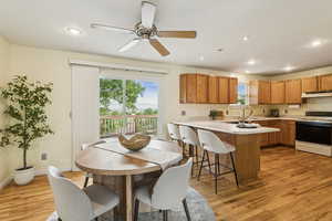 Dining room featuring light wood-type flooring, recessed lighting, and a ceiling fan