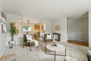 Sitting room featuring carpet flooring, ceiling fan, and a textured ceiling