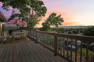 Back deck with outdoor dining space and valley views