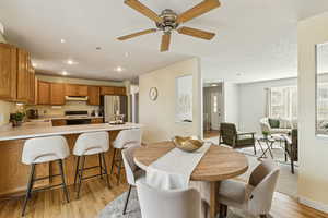 Dining space featuring light wood-style floors, recessed lighting, and ceiling fan