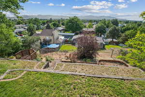Aerial view of property and surrounding area with a mountainous background