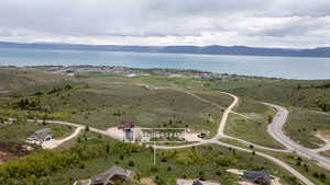 Aerial view of property and surrounding area with a water and mountain view