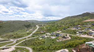 Aerial view of property and surrounding area featuring mountains