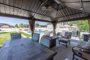 View of patio featuring outdoor dining area, a gazebo, and outdoor lounge area