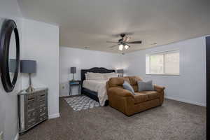 Carpeted bedroom featuring a ceiling fan and baseboards