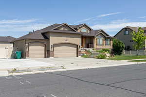View of front of home featuring a garage, stucco siding, driveway, roof with shingles, and a gate