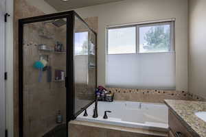Full bath with a bath, a stall shower, and vanity