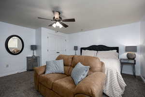 Bedroom with carpet flooring, baseboards, a closet, and a ceiling fan