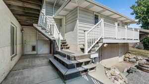 View of side of property with stairs and a patio