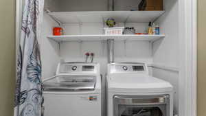 Washroom featuring washing machine and clothes dryer