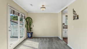 Semi Formal Dining room featuring carpet floors, ornamental molding, and baseboards