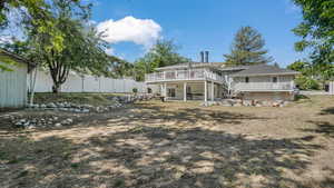 Back of house with stairs and a wooden deck