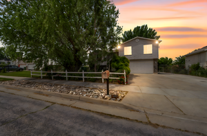 View of front of property featuring driveway and a garage