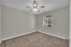 Unfurnished room with carpet, baseboards, and ceiling fan