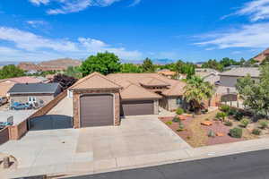Mediterranean / spanish-style home with a gate, a garage, concrete driveway, a tile roof, and a mountain view