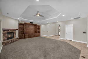Unfurnished living room featuring ceiling fan, recessed lighting, arched walkways, baseboards, and light tile patterned floors