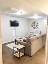 Living room featuring carpet floors and baseboards