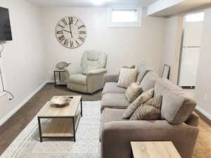 Living area featuring carpet flooring and baseboards