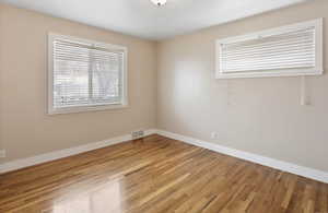 Unfurnished room featuring baseboards and light wood-style floors