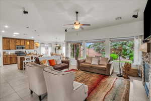 Living area with plenty of natural light, ceiling fan, light tile patterned floors, and recessed lighting