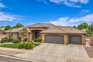 View of front of home featuring stucco siding, a garage, concrete driveway, and a tiled roof